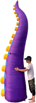 Giant purple octopus tentacle inflatable with orange suckers next to a man for scale