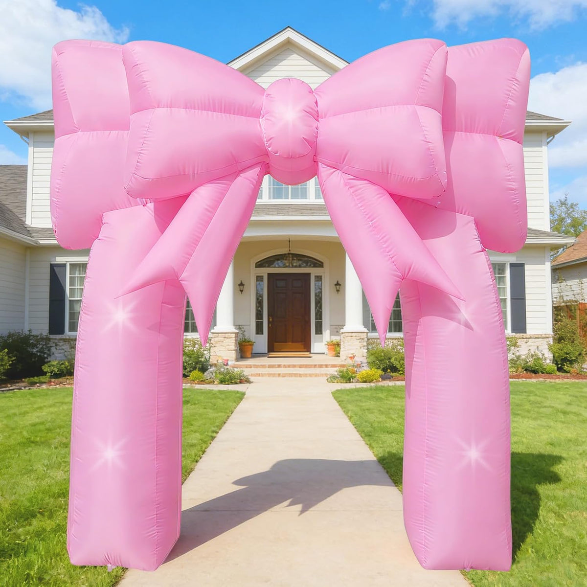 Giant pink bow inflatable arch over a front walkway