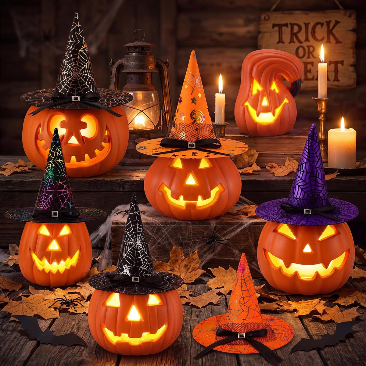 Group of small glowing jack-o'-lanterns wearing orange, purple and black witch hats