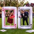 Two giant inflatable playing card frames, Queen of Hearts and King of Spades, with guests posing inside