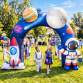 Galaxy print inflatable arch with a rocket, an astronaut and planets at an outdoor kids party