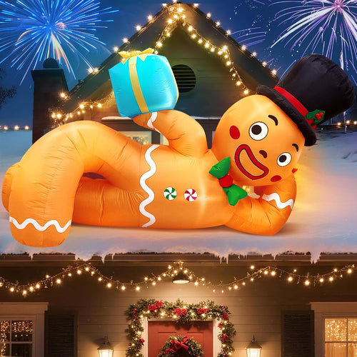 Lying gingerbread man inflatable in a top hat holding a blue gift with fireworks behind