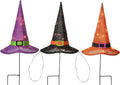 Three pre-lit witch hat garden stakes in purple, black and orange joined by a light wire