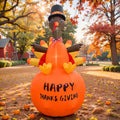 Turkey in a pilgrim hat sitting on a big orange pumpkin inflatable printed Happy Thanksgiving on a fall street
